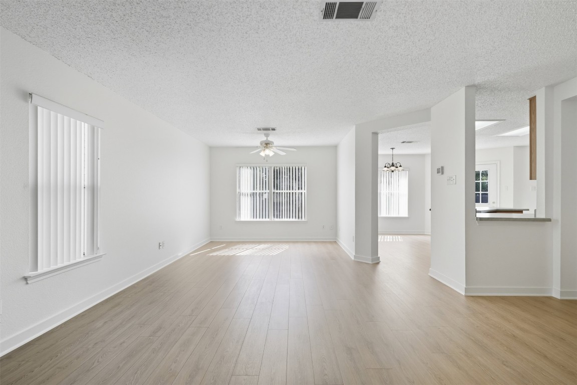 1312 Rosie Lane Cedar Park, TX 78613 - Photo 9 of 38 a view of an empty room with wooden floor and a window