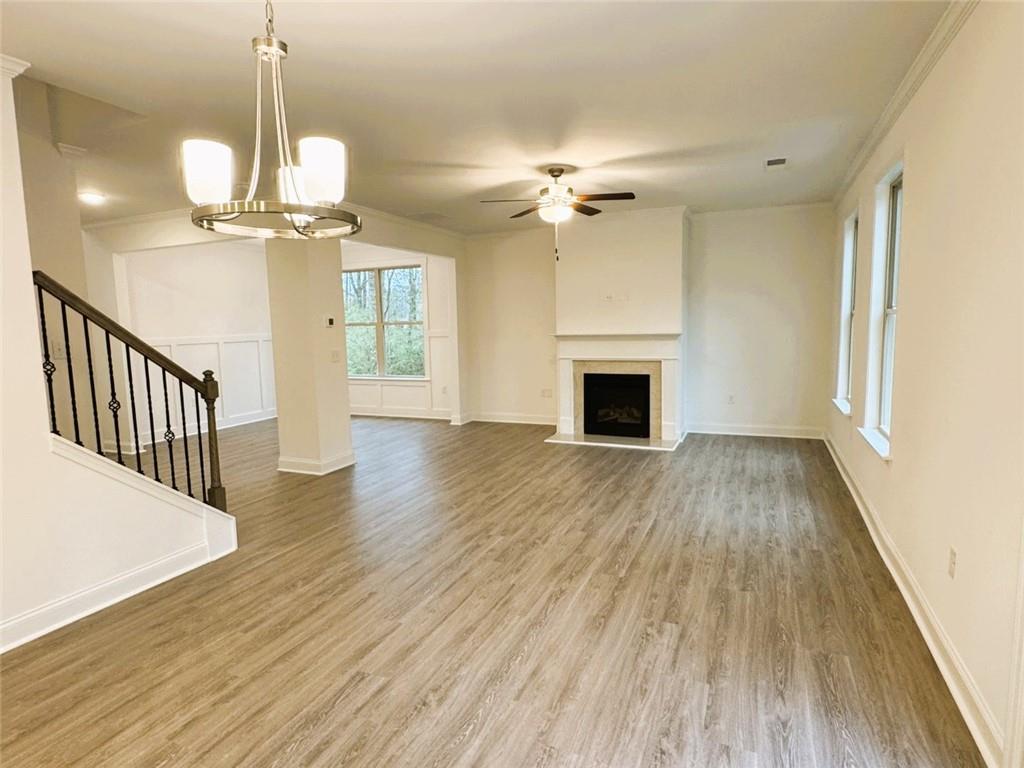2280 Highridge Point Drive Lithia Springs, GA 30122 - Photo 7 of 20 a view of a livingroom with wooden floor and a ceiling fan