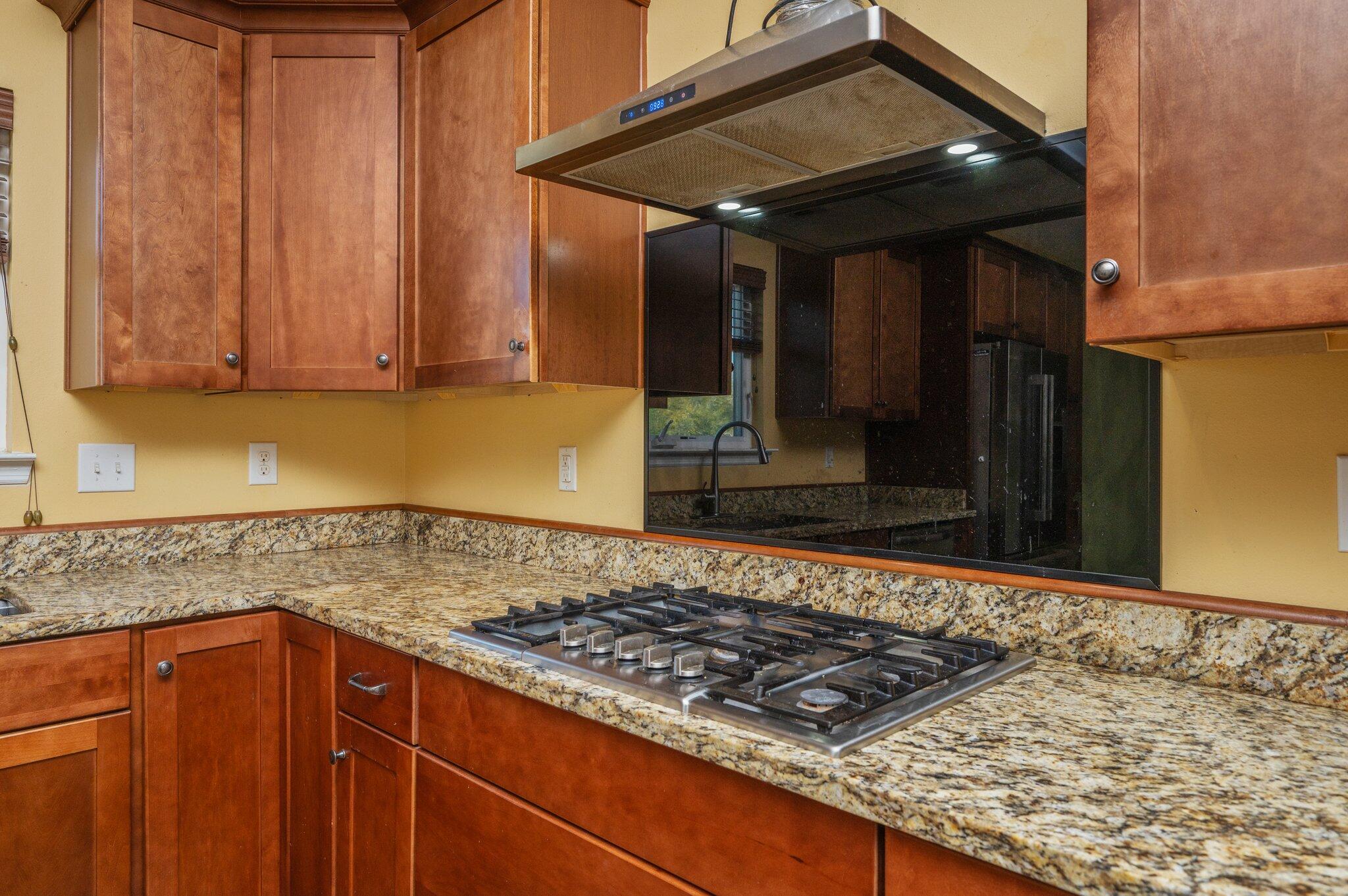 5026 Leitmann Road Baker, FL 32531 - Photo 11 of 65 a kitchen with wooden cabinets and a stove top oven