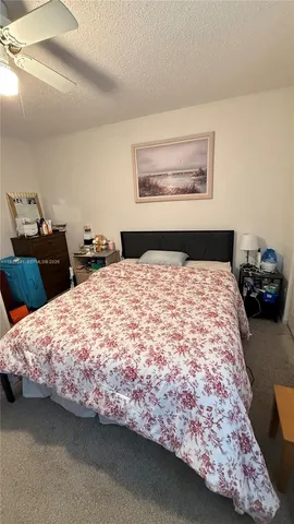 a bedroom with a bed and dresser
