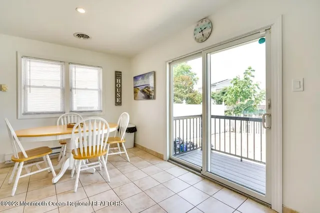 a view of a dining room with furniture and windows