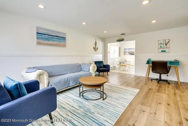 a living room with furniture and a rug