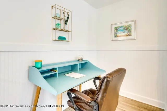 a view of a room with furniture and wooden floor