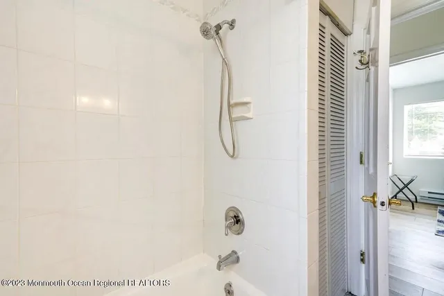 a bathroom with a glass shower door