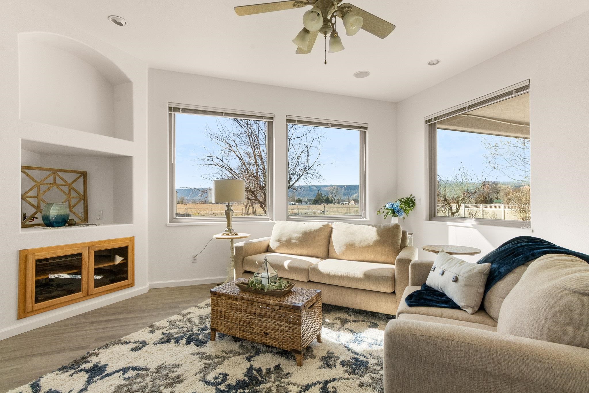2107 I I- 1/2 Road Grand Junction, CO 81505 - Photo 19 of 42 a living room with furniture a fireplace and a large window
