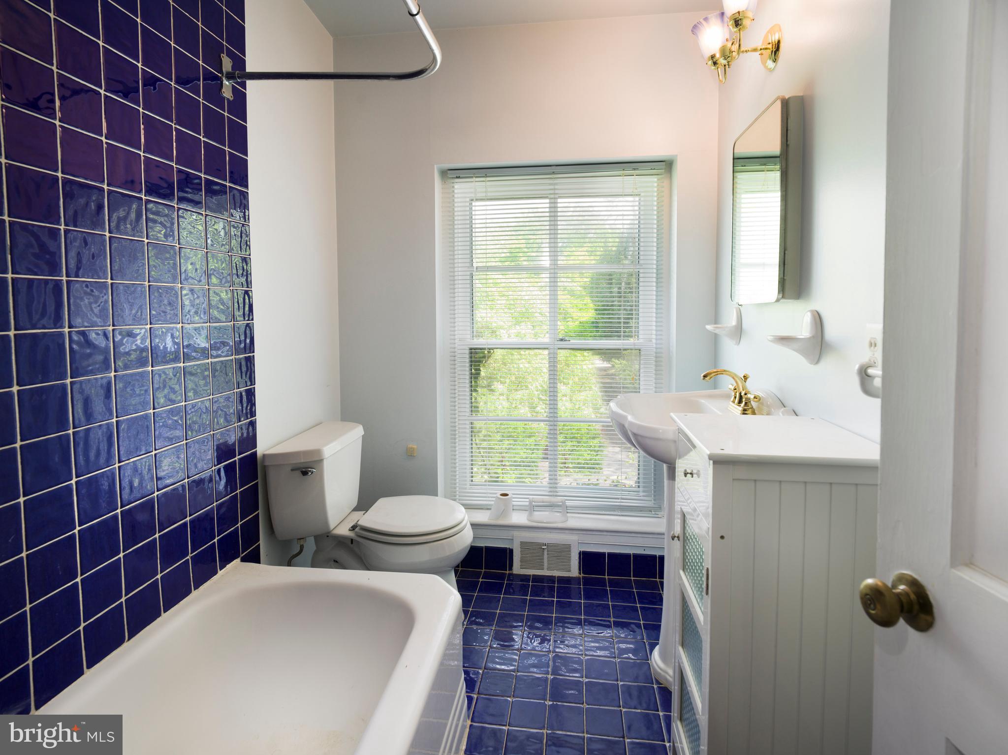 1114 Brynlawn Road Villanova, PA 19085 - Photo 23 of 24 a bathroom with a toilet a sink and window