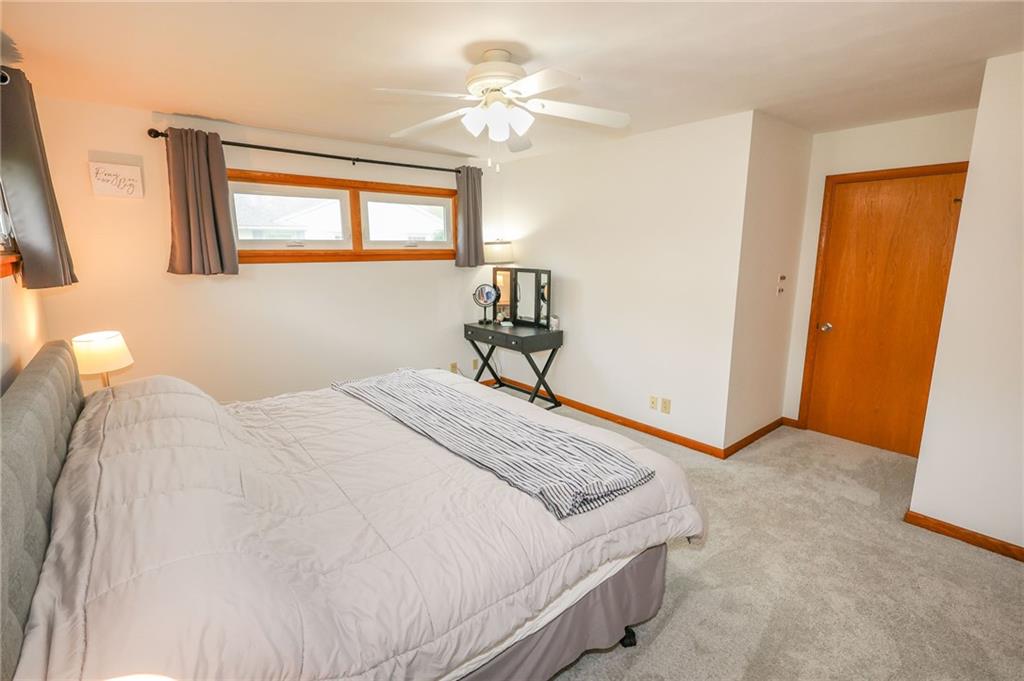 3689 Ridgewood Drive Hermitage, PA 16148 - Photo 19 of 49 a bedroom with a bed and a chandelier