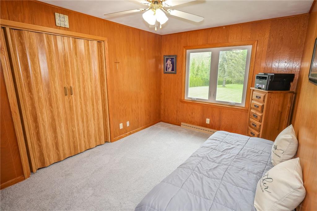 3689 Ridgewood Drive Hermitage, PA 16148 - Photo 24 of 49 a bedroom with a bed and a chandelier