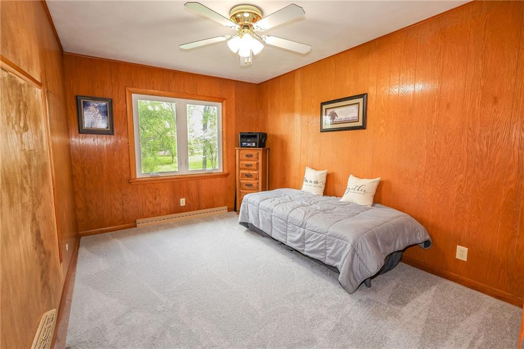 3689 Ridgewood Drive Hermitage, PA 16148 - Photo 25 of 49 a bedroom with a bed and a chandelier