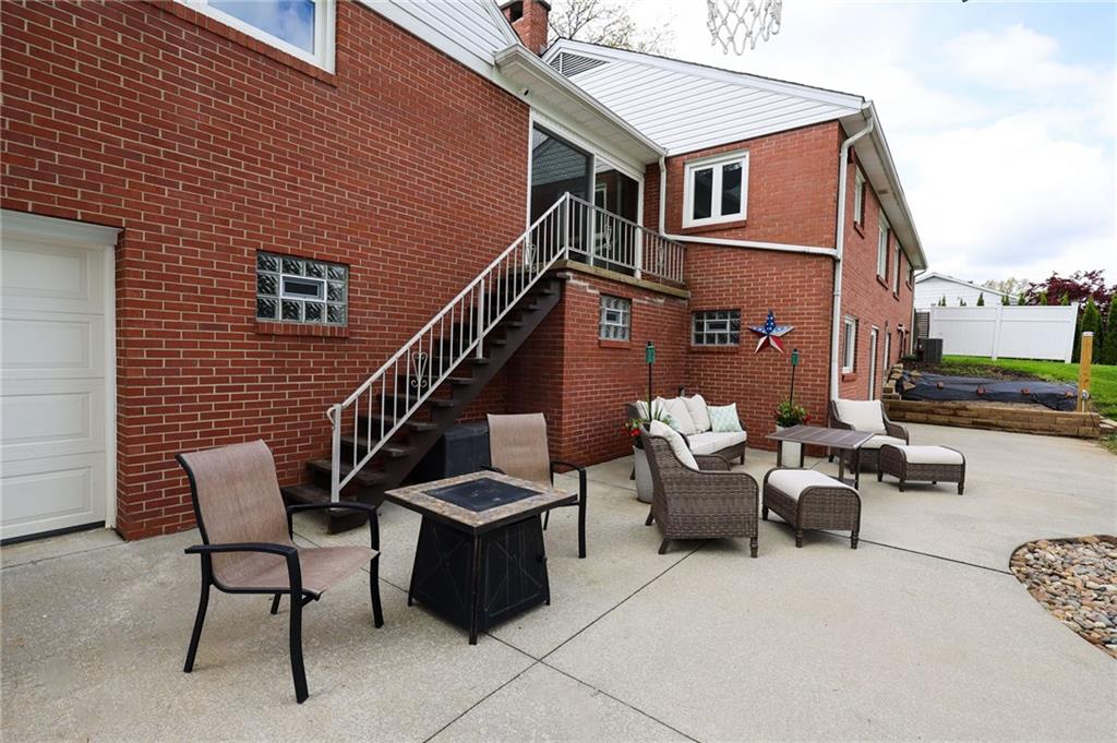 3689 Ridgewood Drive Hermitage, PA 16148 - Photo 38 of 49 a view of a patio with couches table and chairs with wooden floor
