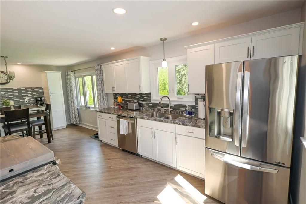 3689 Ridgewood Drive Hermitage, PA 16148 - Photo 9 of 49 a kitchen with stainless steel appliances a refrigerator and wooden cabinets