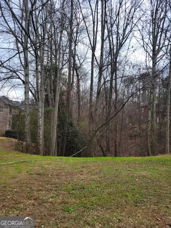 a backyard of a house with large trees