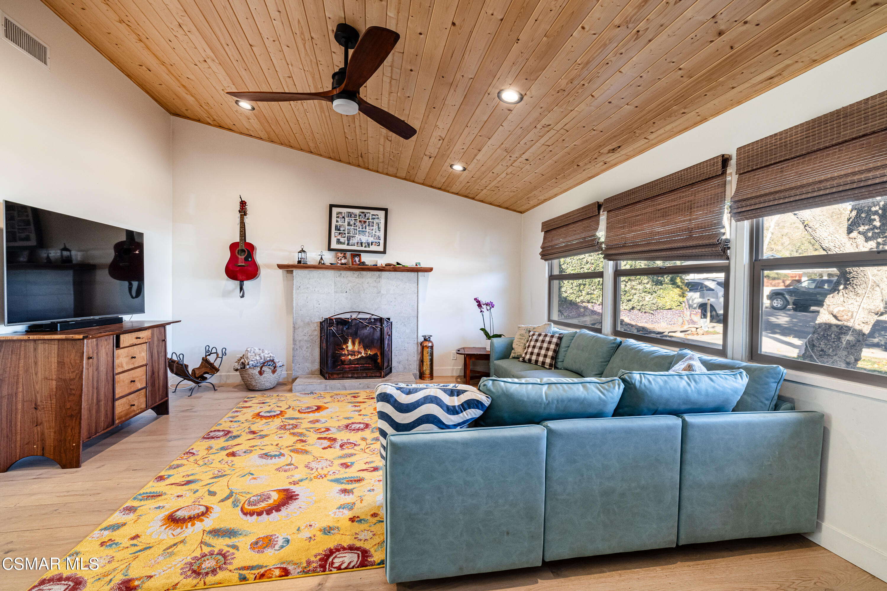1405 Meadowbrook Road Ojai, CA 93023 - Photo 4 of 25 a living room with furniture a flat screen tv and a fireplace