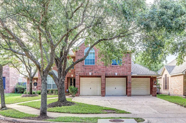 front a house with a tree in front of it