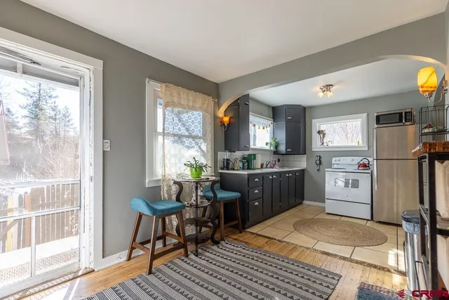 a living room with furniture a window and wooden floor