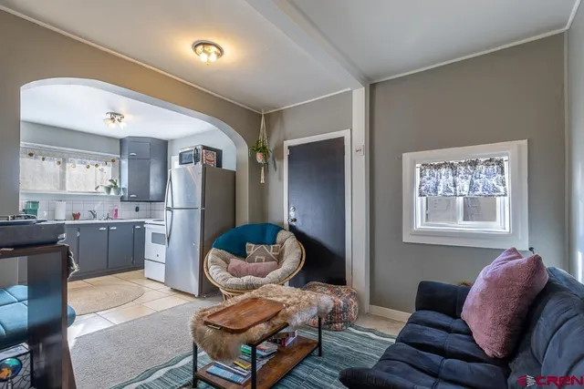 a kitchen with a refrigerator and windows