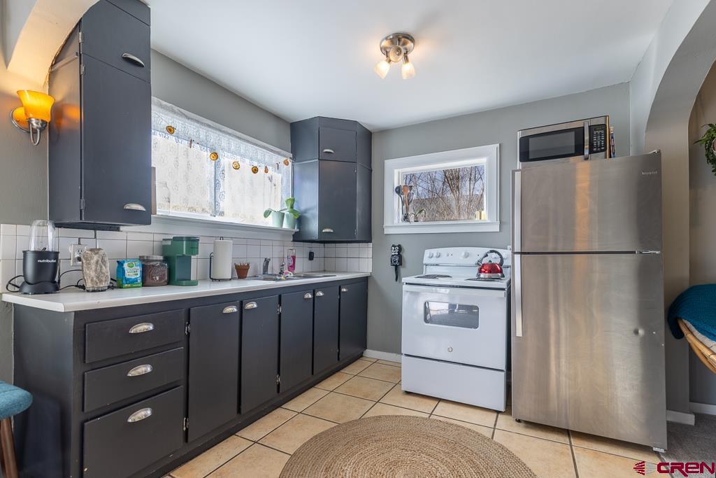 3533 Main Avenue Durango, CO 81301 - Photo 11 of 19 a kitchen with stainless steel appliances a refrigerator sink and cabinets