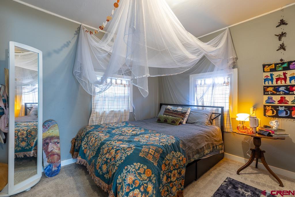 3533 Main Avenue Durango, CO 81301 - Photo 12 of 19 a bedroom with a bed a bookshelf and a window