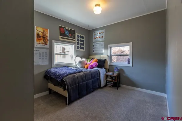 a living room with a bed furniture and a window