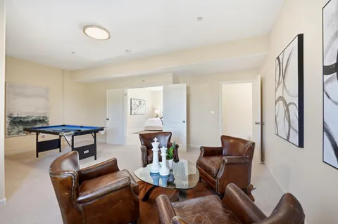 a room with pool table and windows