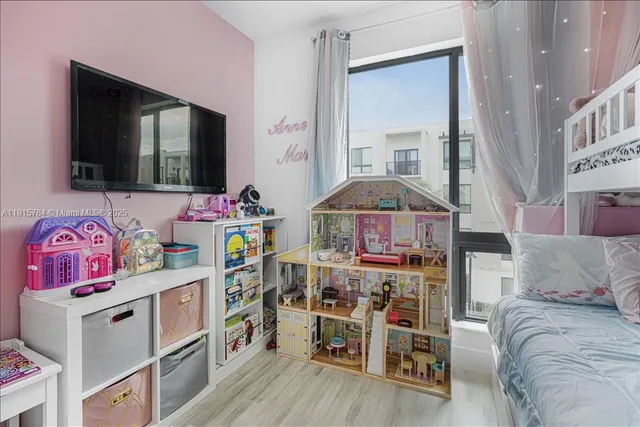 a bedroom with furniture and a flat screen tv