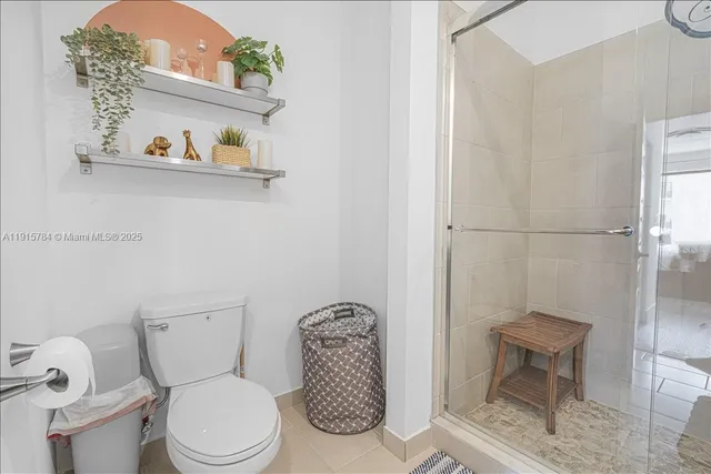 a white toilet sitting next to a bathroom sink