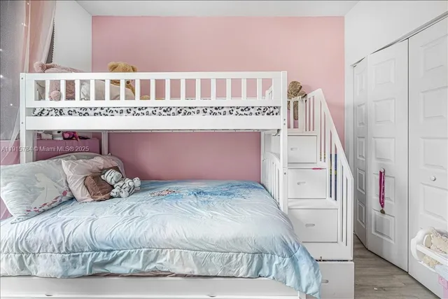 a bedroom with a bed and a book shelf