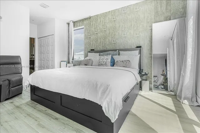 a bedroom with a bed table and a couch