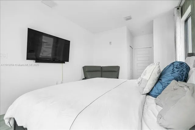 a view of a room with furniture and wooden floor