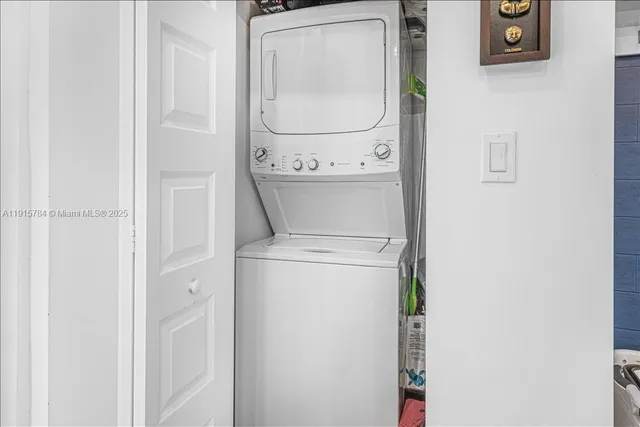 a living room with lots of furniture and kitchen view
