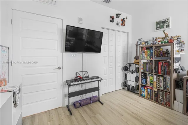 a view of a porch with a floor to ceiling window and wooden fence