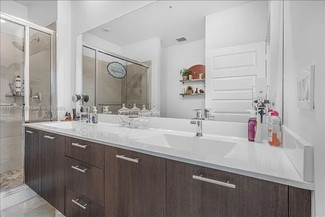 a bathroom with a double vanity sink and a mirror
