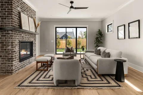a living room with furniture fireplace and a table