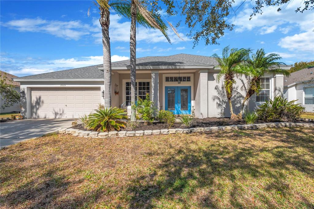 19015 Fern Meadow Loop Lutz, FL 33558 - Photo 1 of 50 a front view of a house with a yard