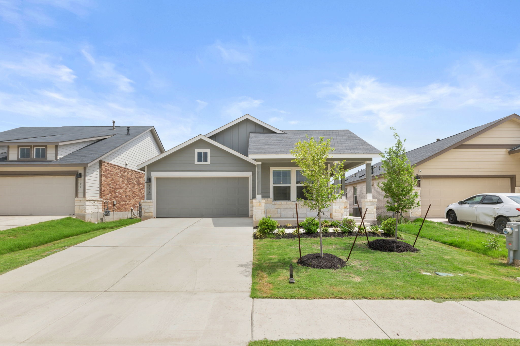 185 Sormonne Loop Kyle, TX 78640 - Photo 1 of 40 a front view of house with a garden and trees