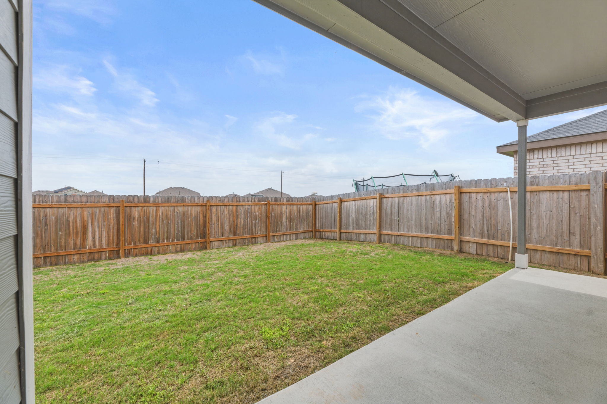 185 Sormonne Loop Kyle, TX 78640 - Photo 36 of 40 a view of a backyard with a garden