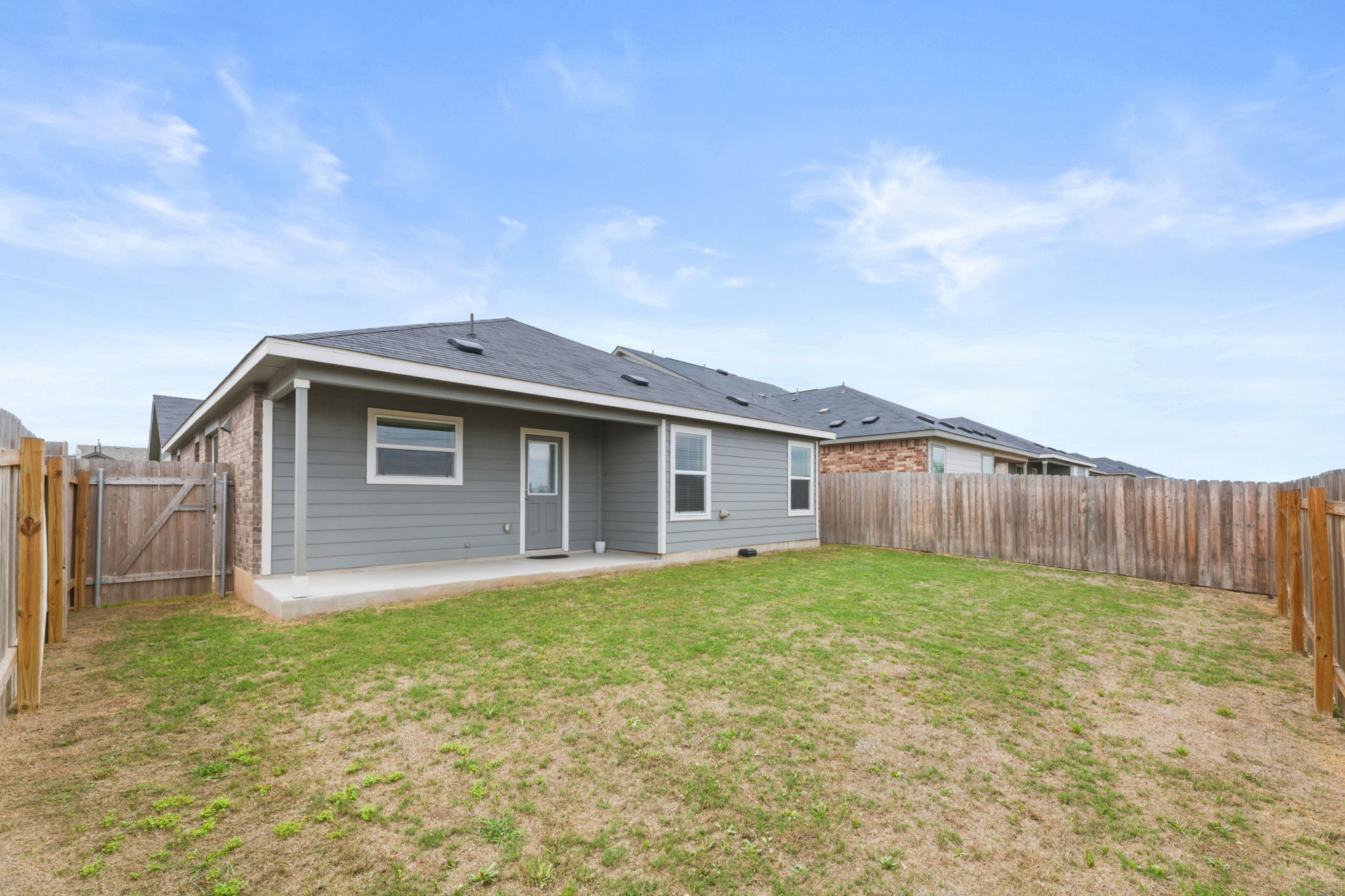 185 Sormonne Loop Kyle, TX 78640 - Photo 37 of 40 a view of a house with a yard and fence