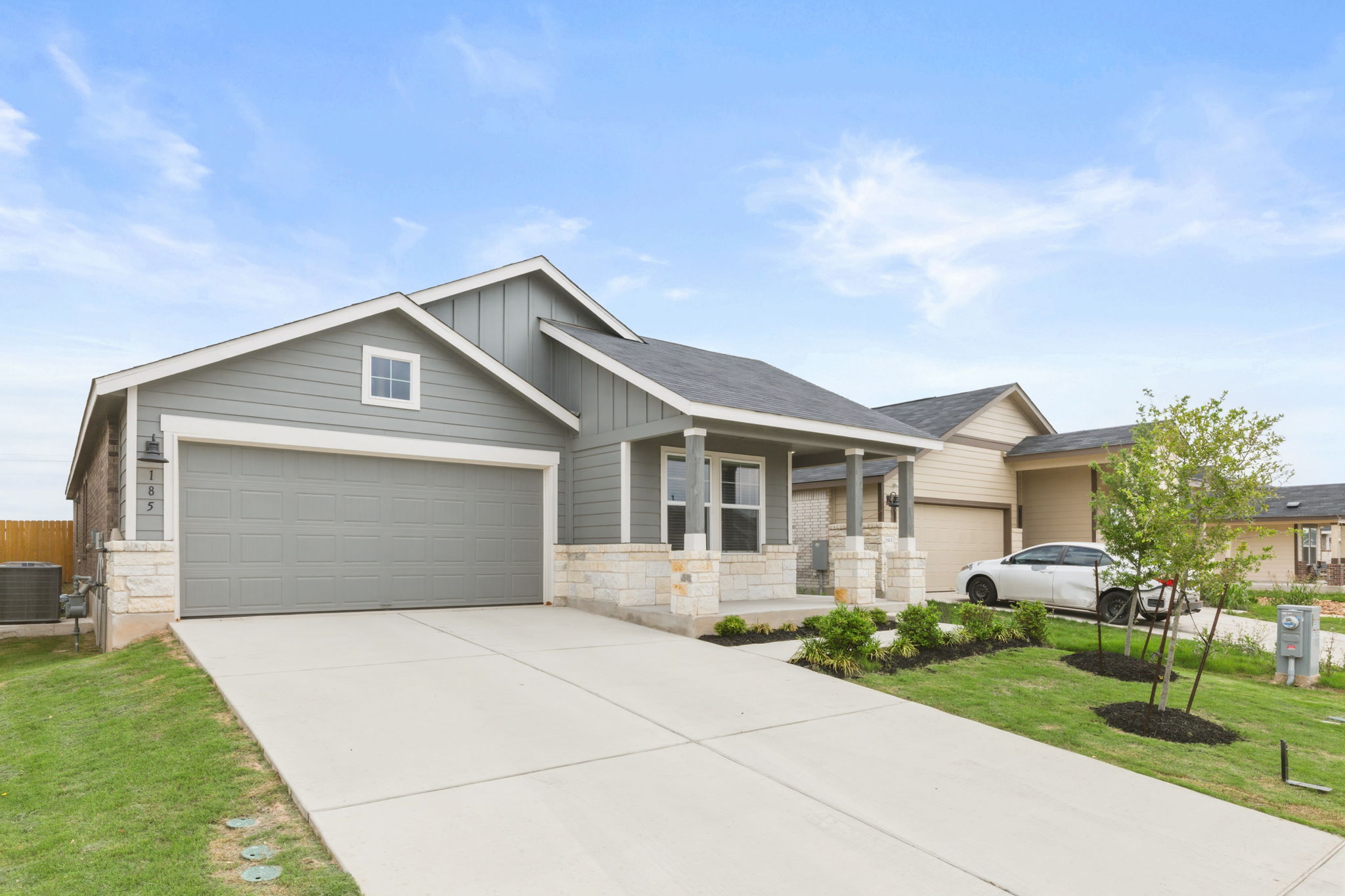 185 Sormonne Loop Kyle, TX 78640 - Photo 4 of 40 a front view of a house with a yard and garage