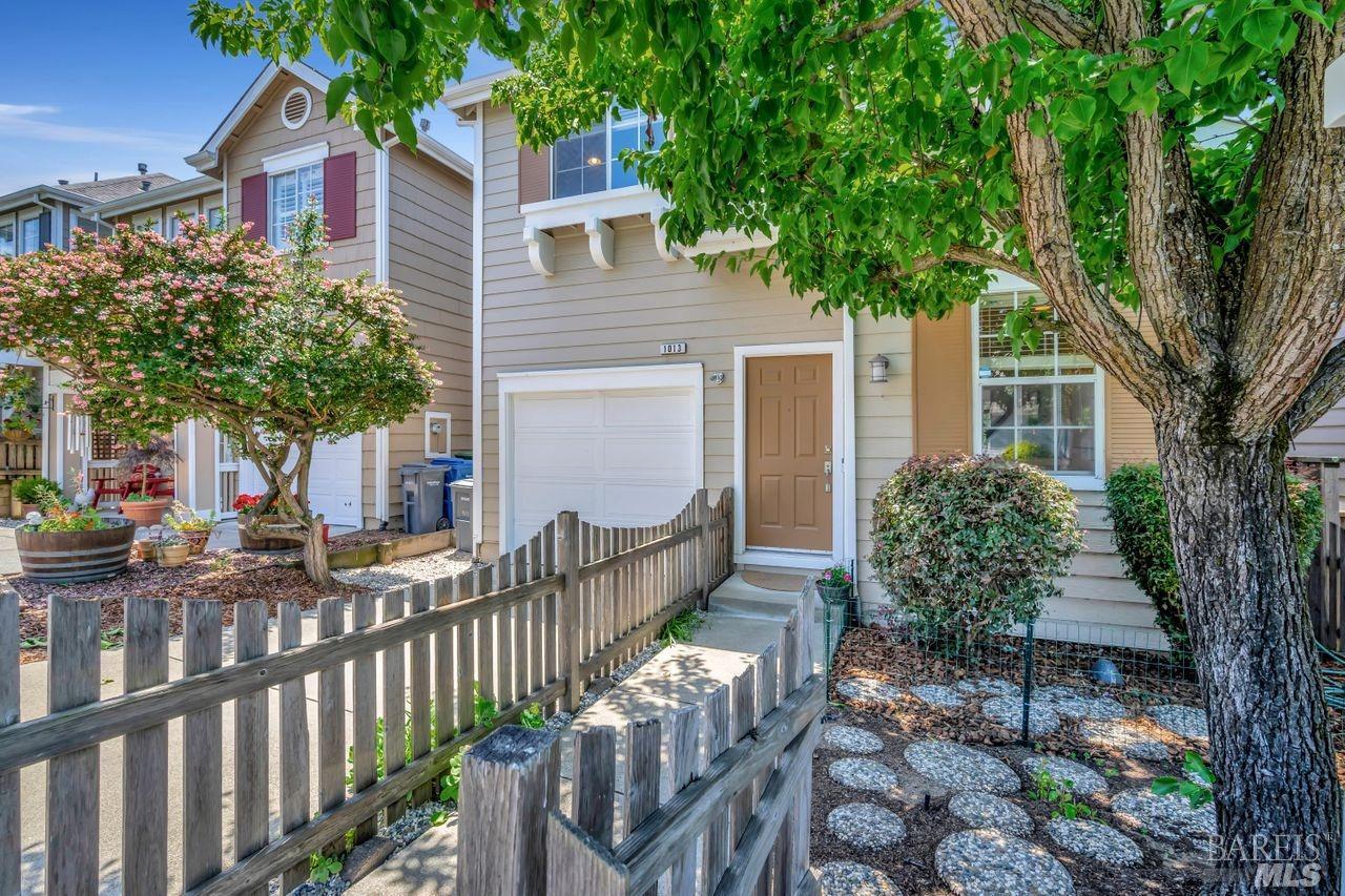 a view of a house with backyard and sitting area