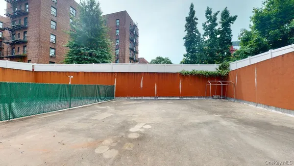 a view of backyard of house with large trees