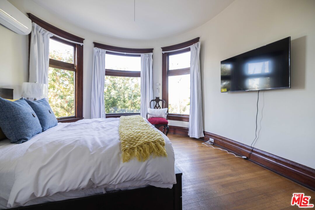 a bedroom with a bed and a flat screen tv