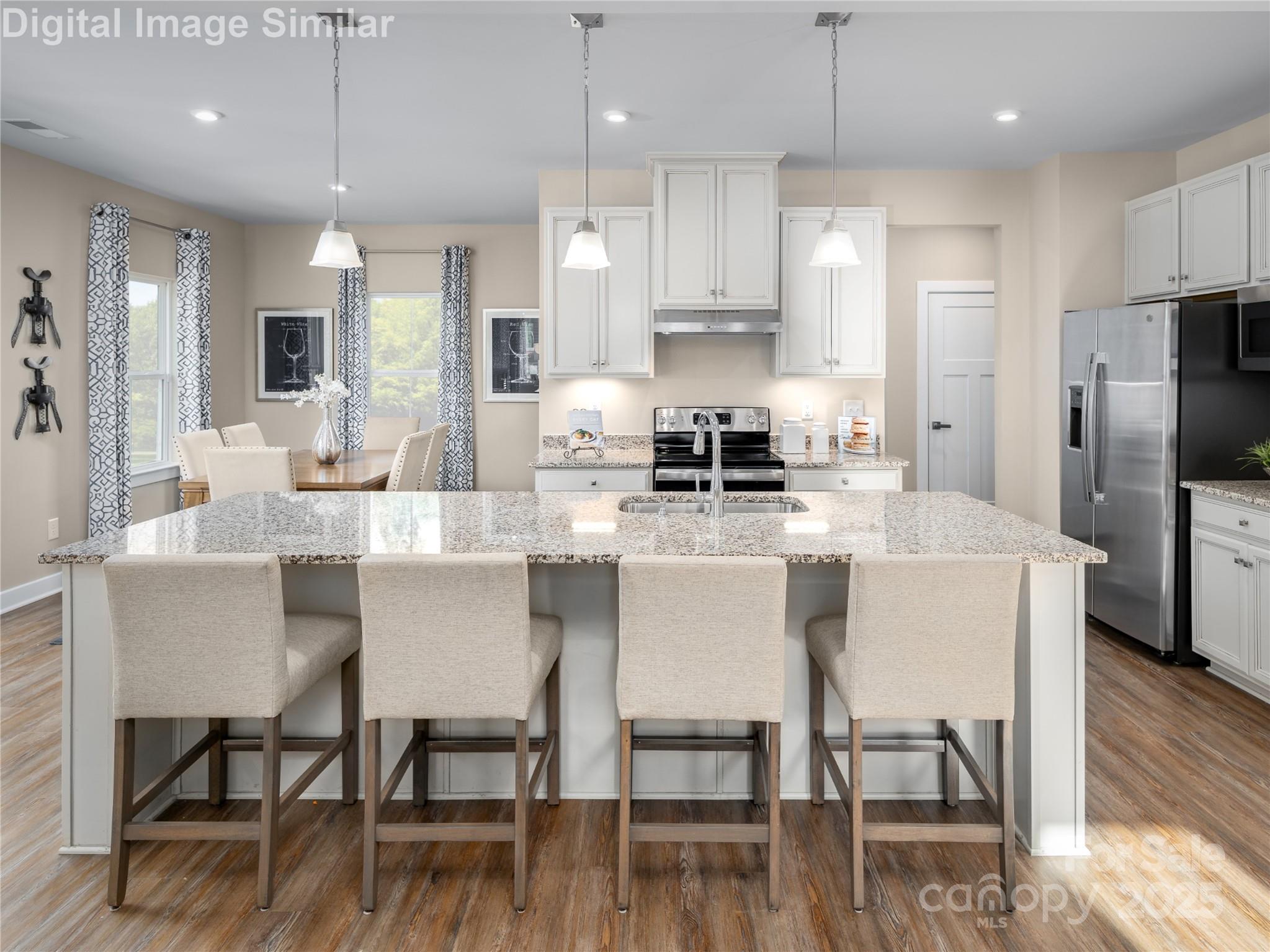 7538 West Berkeley Road Denver, NC 28037 - Photo 2 of 33 a kitchen with stainless steel appliances kitchen island granite countertop a dining table chairs refrigerator and microwave