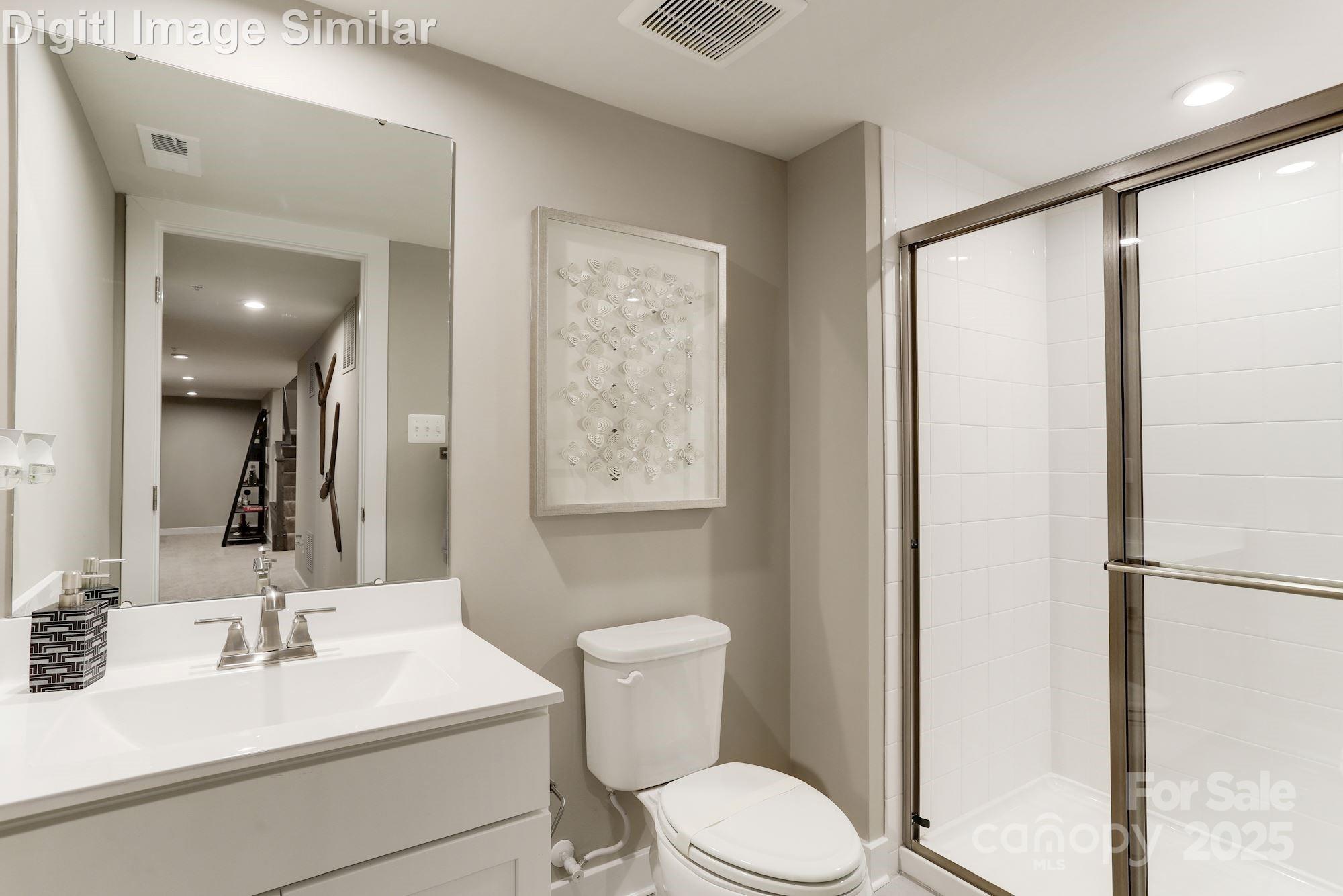7538 West Berkeley Road Denver, NC 28037 - Photo 24 of 33 a bathroom with a sink mirror vanity and toilet