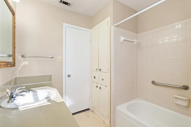 a bathroom with a granite countertop sink mirror and a toilet