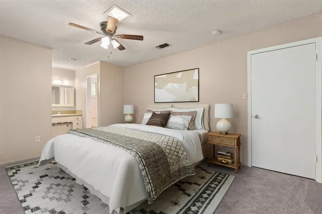 a bedroom with a bed and a potted plant