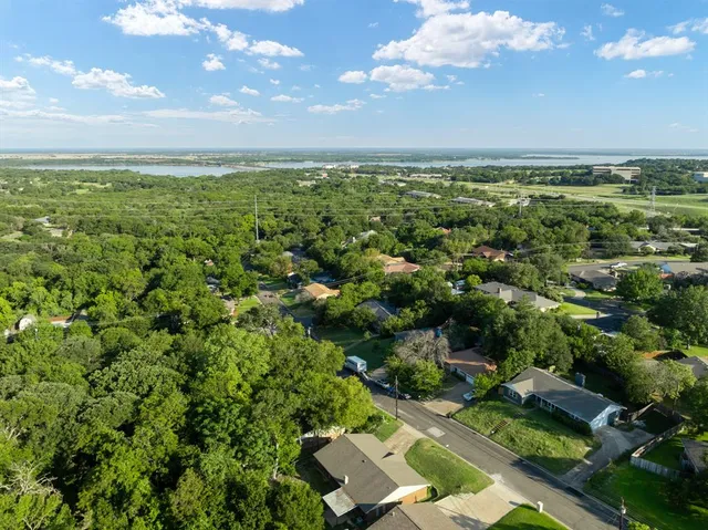 an aerial view of a houses with a yard