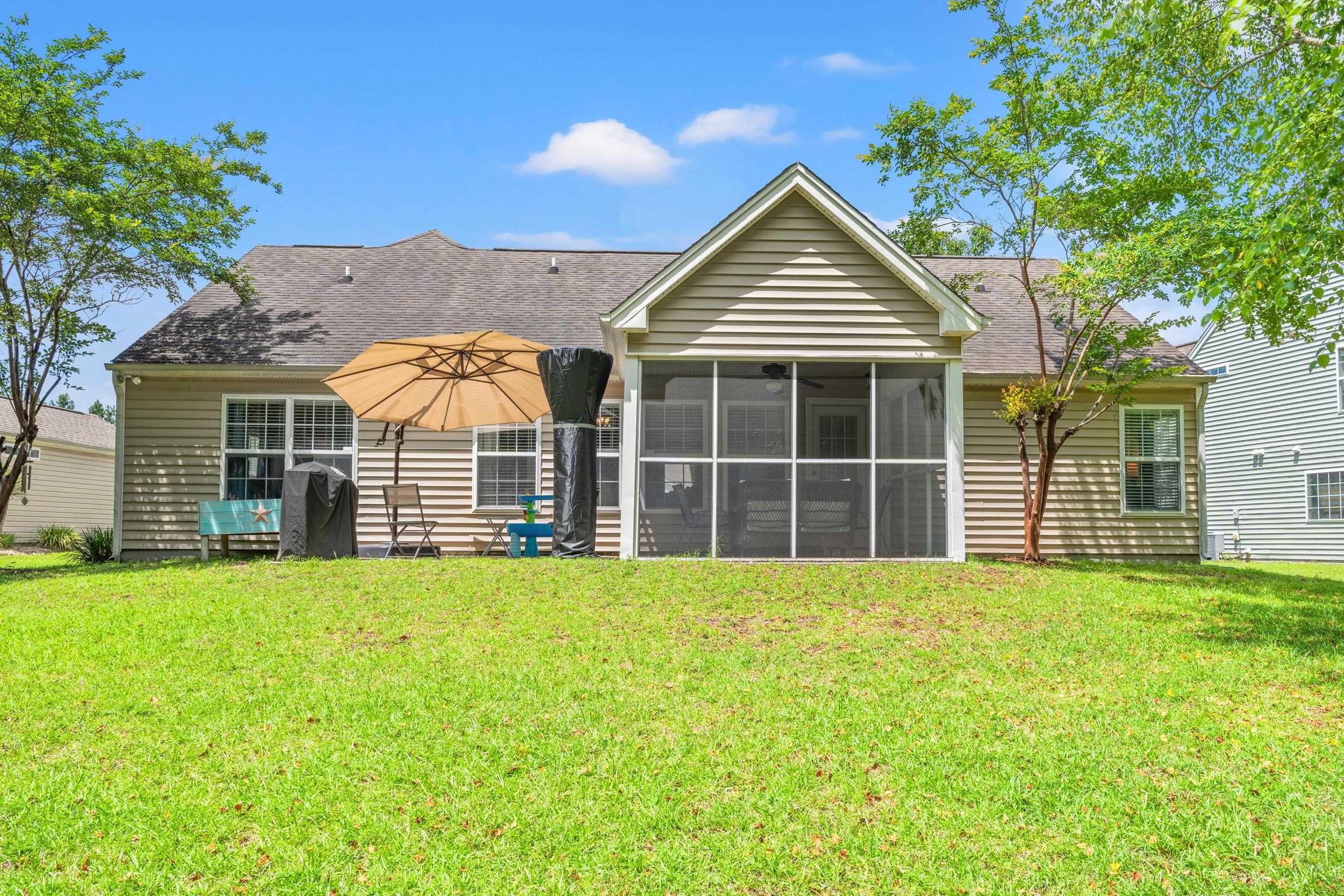 2487 Windmill Way Myrtle Beach, SC 29579 - Photo 9 of 40 Back of house featuring a yard, a sunroom, and a shingled roof