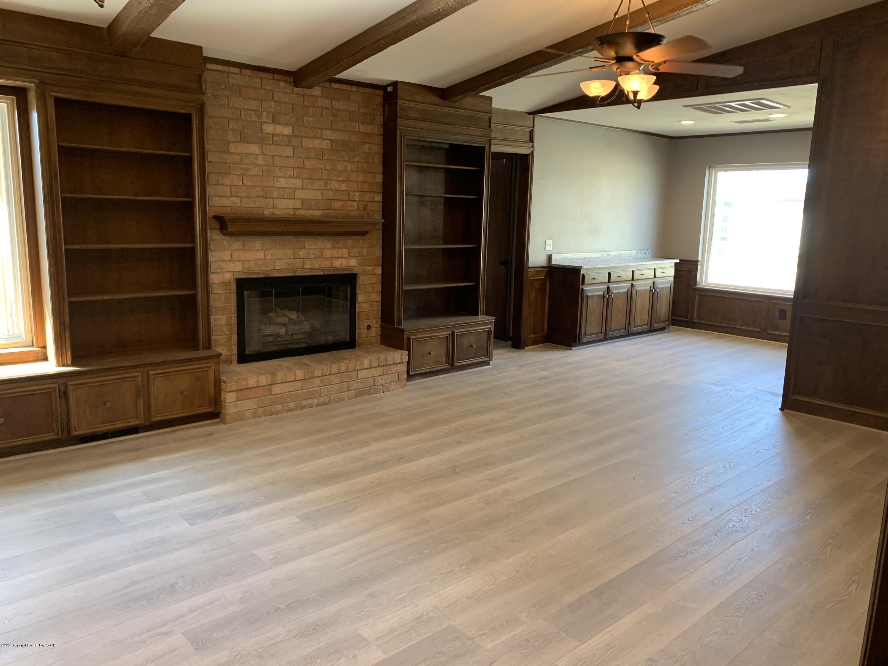 6905 Dreyfuss Road Amarillo, TX 79106 - Photo 4 of 19 wooden floor fireplace and windows in an empty room