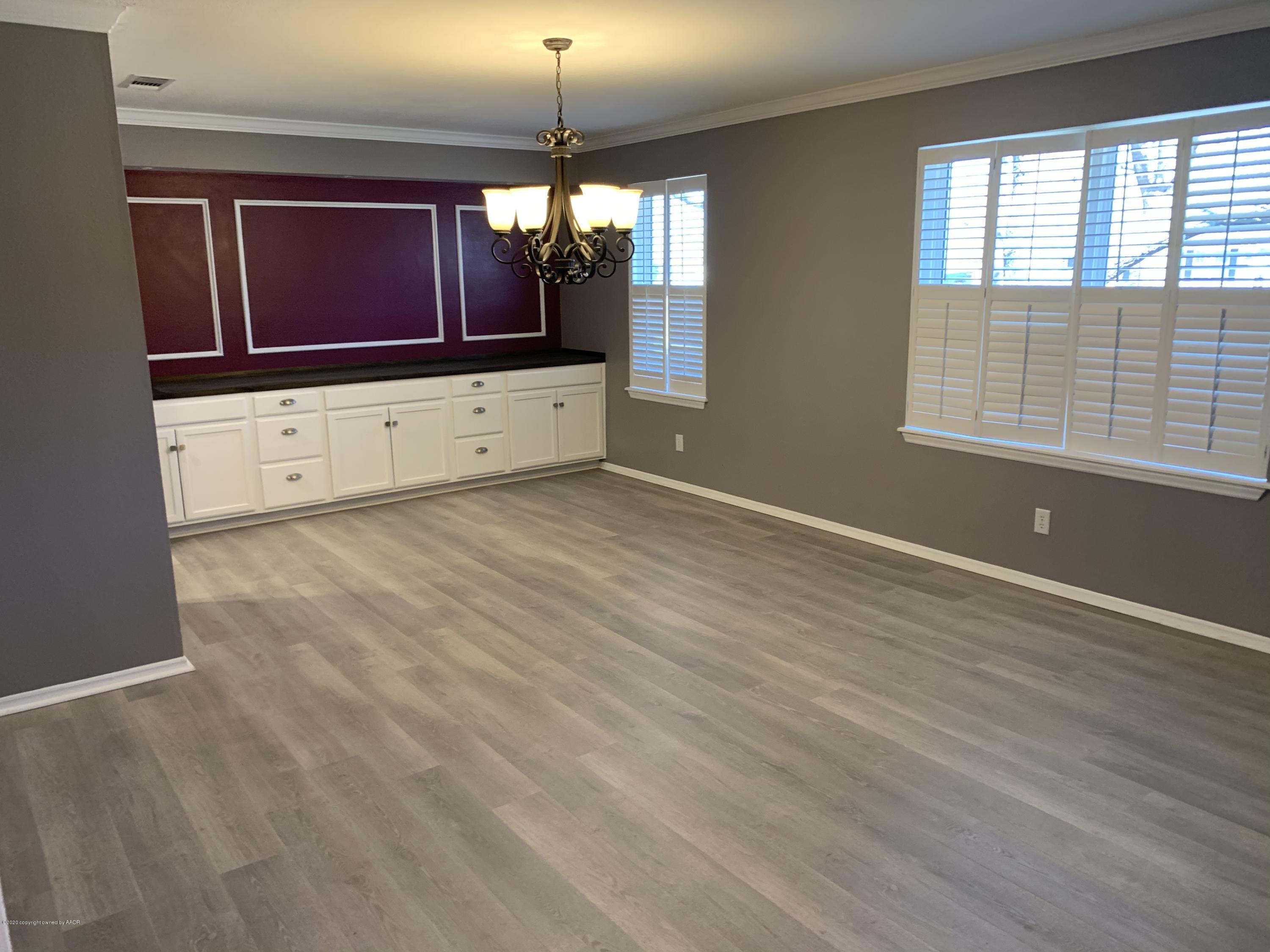 6905 Dreyfuss Road Amarillo, TX 79106 - Photo 8 of 19 a view of room with wooden floor and chandelier