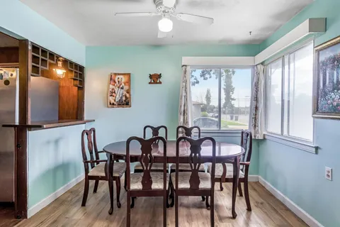 a large kitchen with stainless steel appliances a sink and a refrigerator